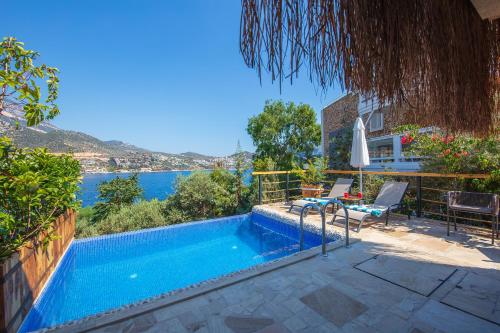 a swimming pool with a view of the water at Likya Gardens Hotel in Kas