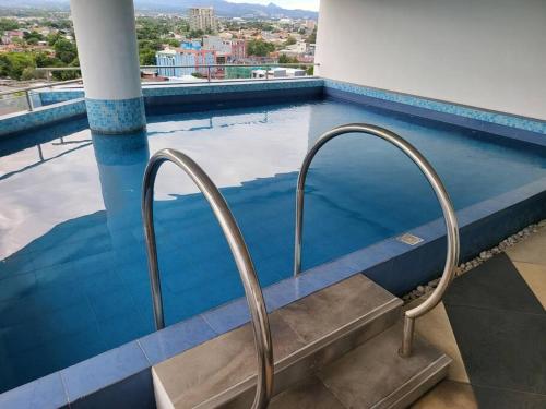 a swimming pool with a stairway leading into a swimming pool at Kandi comfortable 1bedroom, king bed, housekeeping in Angeles