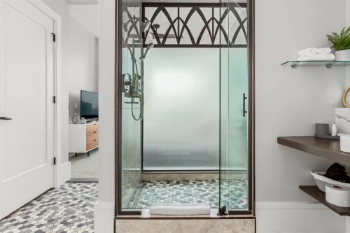 a shower with a glass door in a bathroom at 'Mountain Serenity' A Luxury Downtown Condo with Mountain Views at Arras Vacation Rentals in Asheville