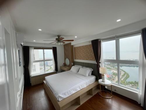 a bedroom with a bed and a large window at Homestay Bai Chay Ha Long ( Ocean View) in Ha Long