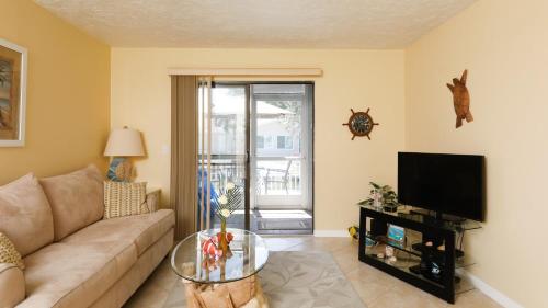a living room with a couch and a tv at 9141 Lake #102 in Englewood