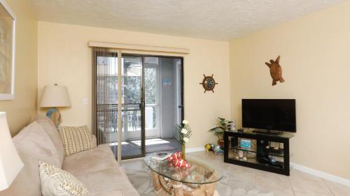 a living room with a couch and a tv at 9141 Lake #102 in Englewood