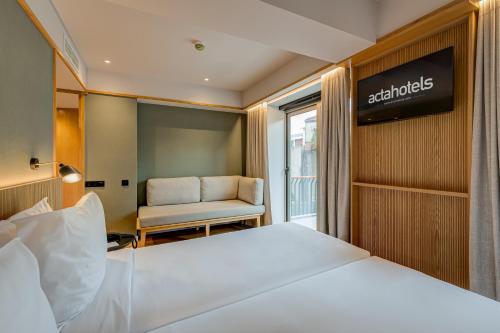 a hotel room with a bed and a chair at Acta The Clover in Porto