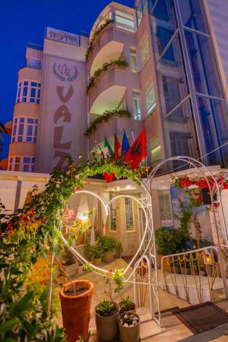 a building with a lot of plants in front of it at Hotel Valz in Velipojë