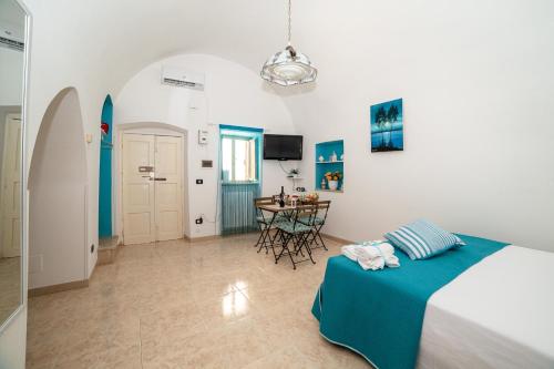 a bedroom with a bed and a table in it at Casa GianAngel Ostuni in Ostuni