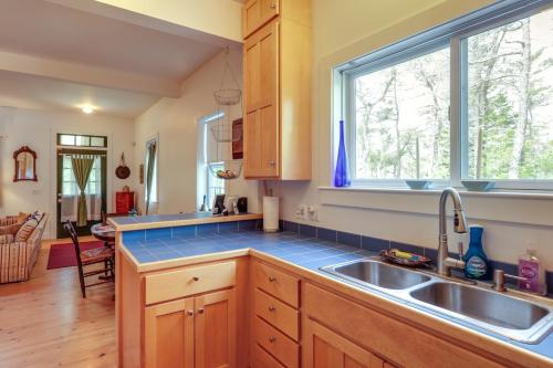 a kitchen with a sink and a window at Enchanting Retreat in Prospect Harbor in Prospect Harbor