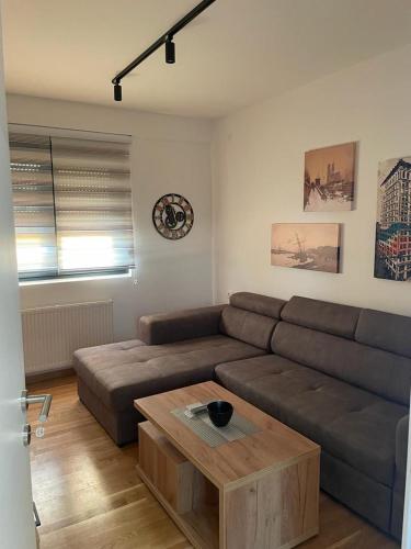 a living room with a couch and a coffee table at luxury Pool Apartment Jagodina in Jagodina