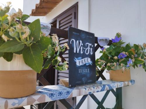 a book sitting on a table with potted plants at Le volte di Umberto in Sogliano Cavour