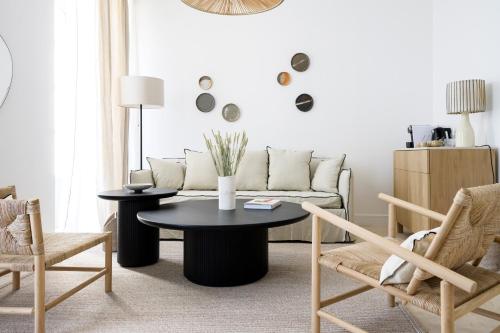 a living room with a couch and a table and chairs at Le Couvent des Minimes, un Hôtel & Spa L'Occitane en Provence in Mane