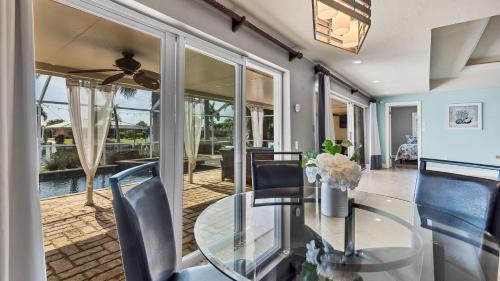 a dining room with a glass table and chairs at 829 Napoli in Punta Gorda