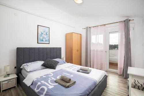 a bedroom with a large bed with towels on it at Apartment Ankica in Medulin