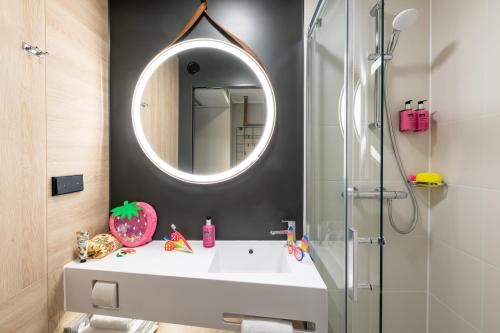 a bathroom with a sink and a mirror at Moxy Dresden Neustadt in Dresden