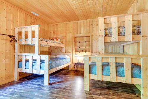 a bedroom with two bunk beds in a cabin at Tranquil La Prairie Retreat with Patio and Fireplace! in La Prairie