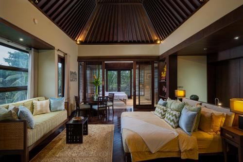 a living room with a couch and a table at The LUXE Ubud - a Boutique Hotel in Ubud