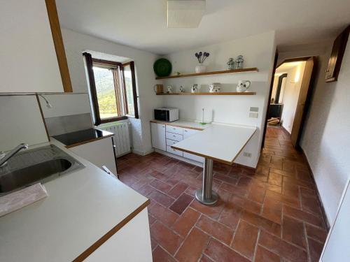 a kitchen with a table in the middle of it at Villa Primula in Monti di Pino