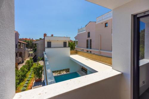 a view from the balcony of a building with a swimming pool at House Neptunia in Medulin