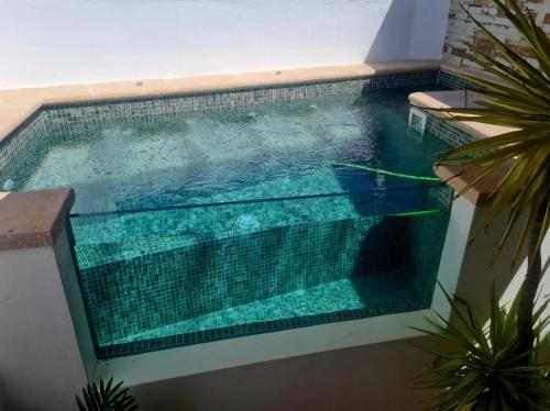 a swimming pool in the middle of a building at La Casa Junto al Sendero del Río & Piscina # aire acondicionado in Los Romeros
