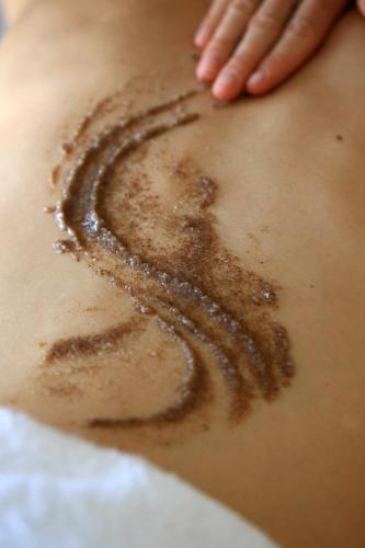 a woman with a hand drawing a swirl on her back at Le Pinarello in Sainte-Lucie de Porto-Vecchio