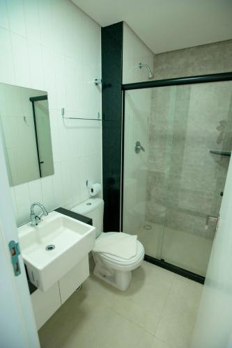 a bathroom with a toilet and a sink and a shower at Porto Star Prime By AFT in Porto De Galinhas