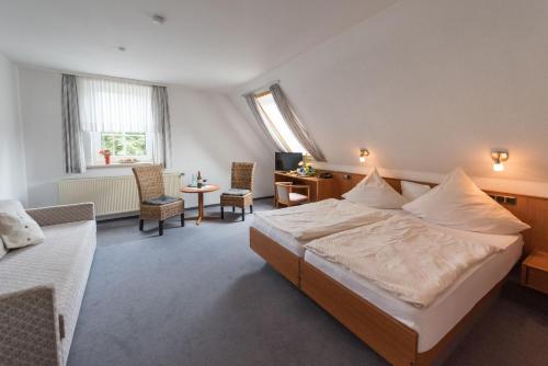 a hotel room with a bed and a desk at Landhotel für Familien und Firmen in Schönhagen