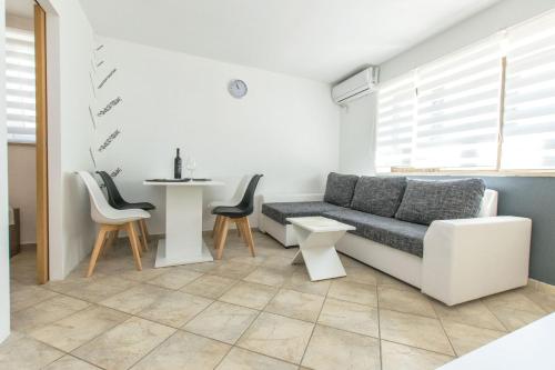 a living room with a couch and a table at Apartment Centar in Postira