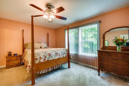 a bedroom with a bed and a dresser and a mirror at Charming Berwick Retreat with Gas Grill and Deck! in Berwick