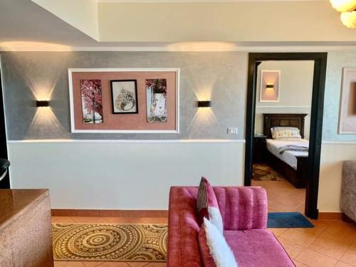 a living room with a couch and a bedroom at Porto Marina Rental in El Alamein