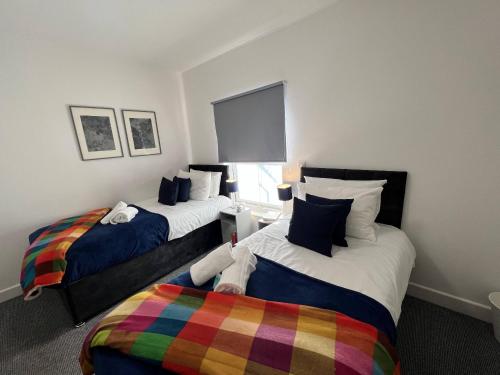 a bedroom with two beds and a window at Stay - The Wellington Burton on Trent in Burton upon Trent