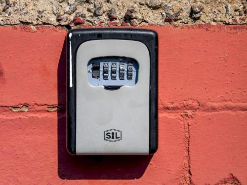 a cell phone is attached to a brick wall at Pass the Keys Private Entrance GF 2 bed flat near Renfrew Centre in Renfrew