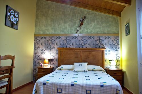 a bedroom with a large bed in a room at casa oliva la bodegueta in Abiego