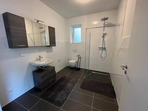 a bathroom with a sink and a shower and a toilet at Stauffenberg Apartments in Albstadt