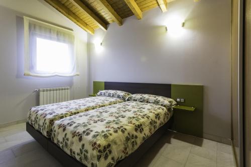 a bedroom with a bed with a floral comforter at Apartamentos Borizu Playa in Barro de Llanes