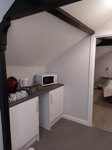 a kitchen with a counter with a microwave on it at EBBERLEY ARMS in Barnstaple