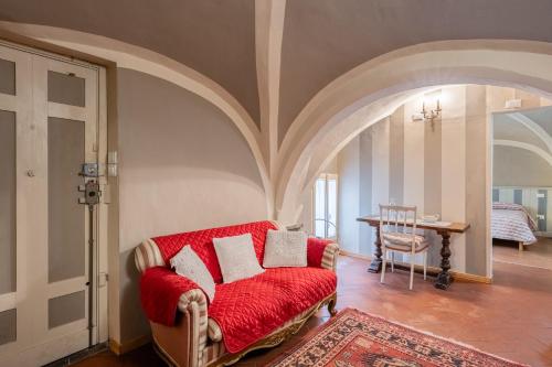 a living room with a red couch and a table at Residenza Gatteschi in Pistoia