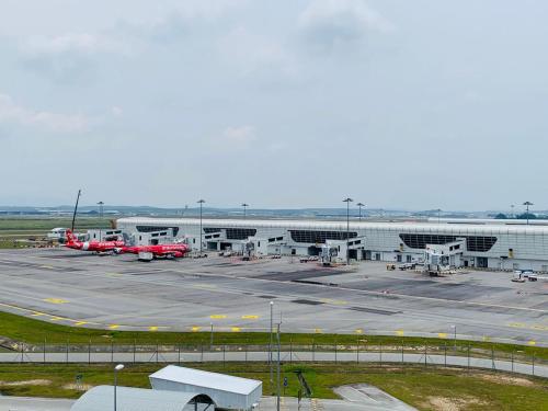 an airport with a parking lot with a red truck at CoreSoho Suite by BKAstaycation KotaWarisan Sepang KLIA Airport, Free Wifi in Sepang