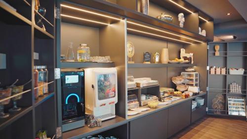 a shop with a computer in a room with shelves at Hotel Heritage Forza in Baška