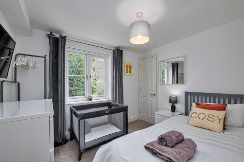 a bedroom with a bed and a sink and a window at Finest Retreats - Y Lle Hapus in Tenby
