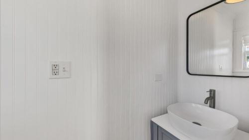 a white bathroom with a sink and a mirror at 307 Taylor #B in Punta Gorda