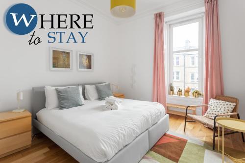 a bedroom with a bed with the words where to stay at Lovely 3 Bedroom apartment Easter Road in Edinburgh