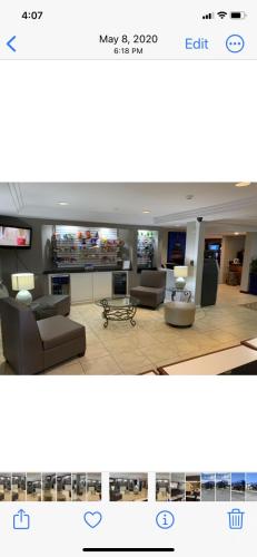 a living room with two couches and a tv at Travelodge Inn & Suites by Wyndham Albany in Albany