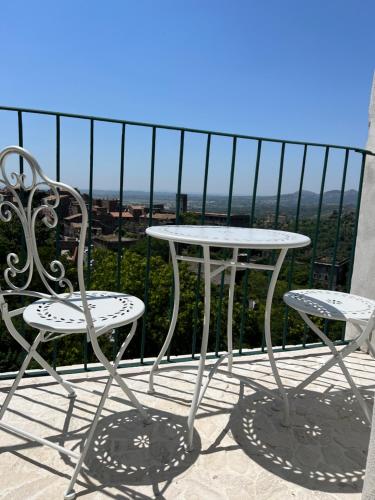 a table and chairs on a balcony with a view at Sibilla 21 Home in Tivoli
