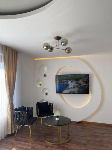 a living room with two chairs and a table at Hotel Panorama in Gjakove