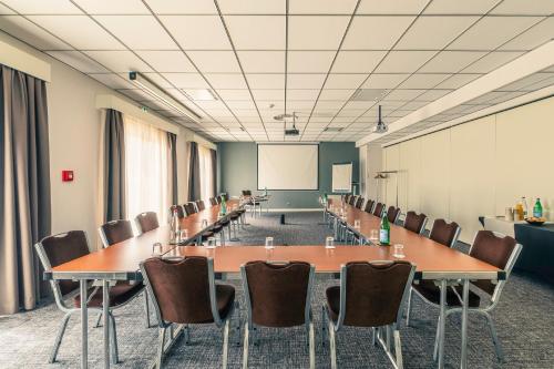 a conference room with a long table and chairs at Best Western Marseille Aeroport in Vitrolles