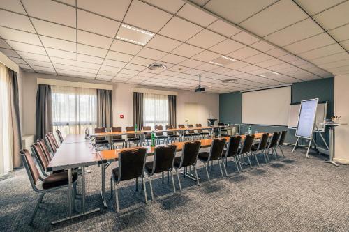 a conference room with a long table and chairs at Best Western Marseille Aeroport in Vitrolles