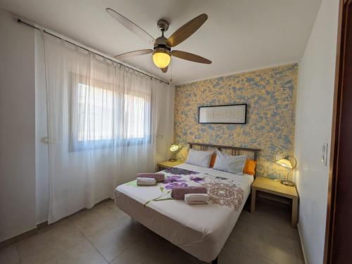 a bedroom with a bed with a ceiling fan at Villa Marina Aguilas Apt. BC1 in Águilas