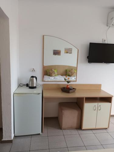 a desk with a mirror and a table with a sink at Alba Family Club Hotel in Primorsko