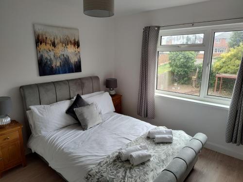 a bedroom with a bed with two towels on it at Wavertree Drive 3 bed contractor home in Leicester in Leicester