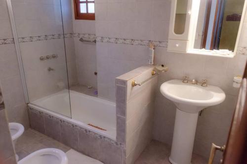 Un baño con ducha, lavabo e inodoro. en Unser traum, en Villa General Belgrano