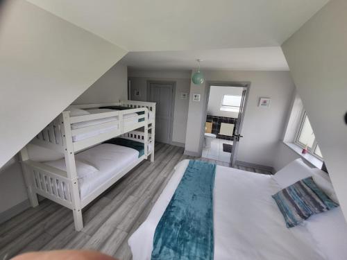 a bedroom with two bunk beds and a staircase at Curragh View in Killybegs