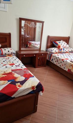 En eller flere senge i et værelse på فيلا 110 قريه سلاح المهندسين